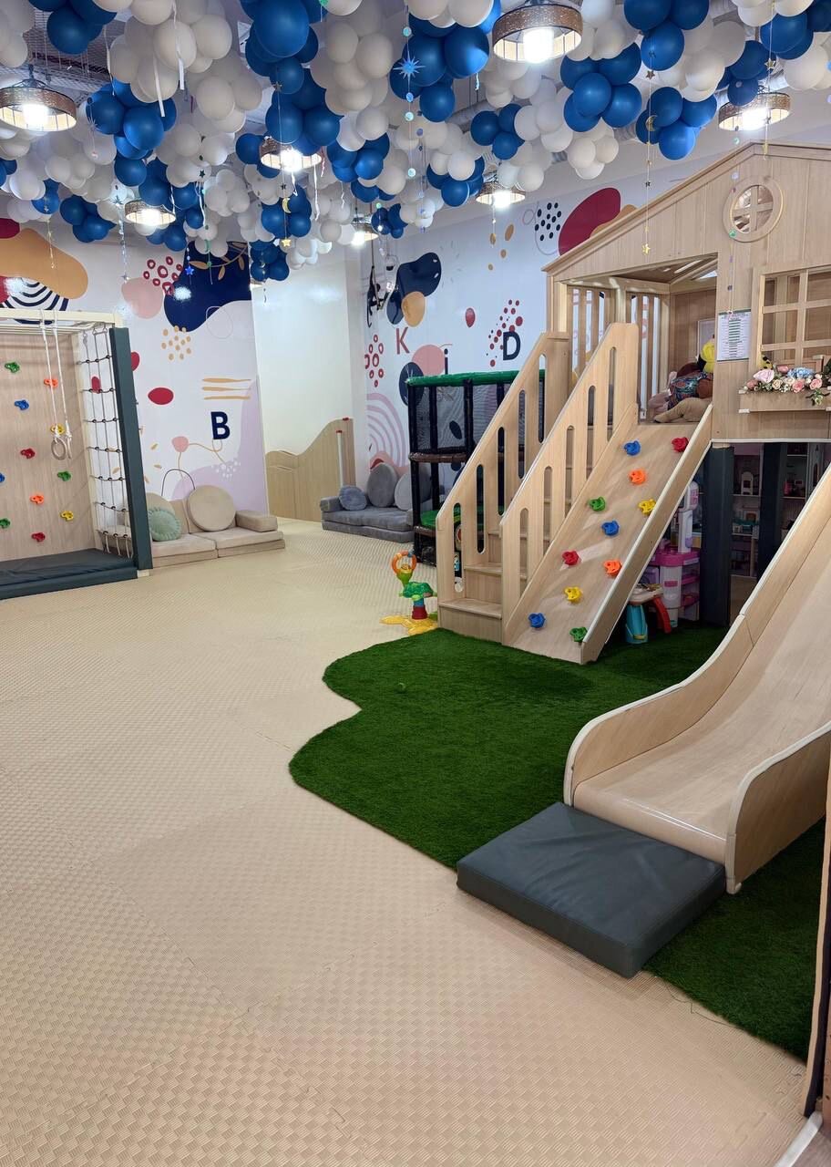 Slide and climbing wall at the Kids Hub indoor playground in Dubai